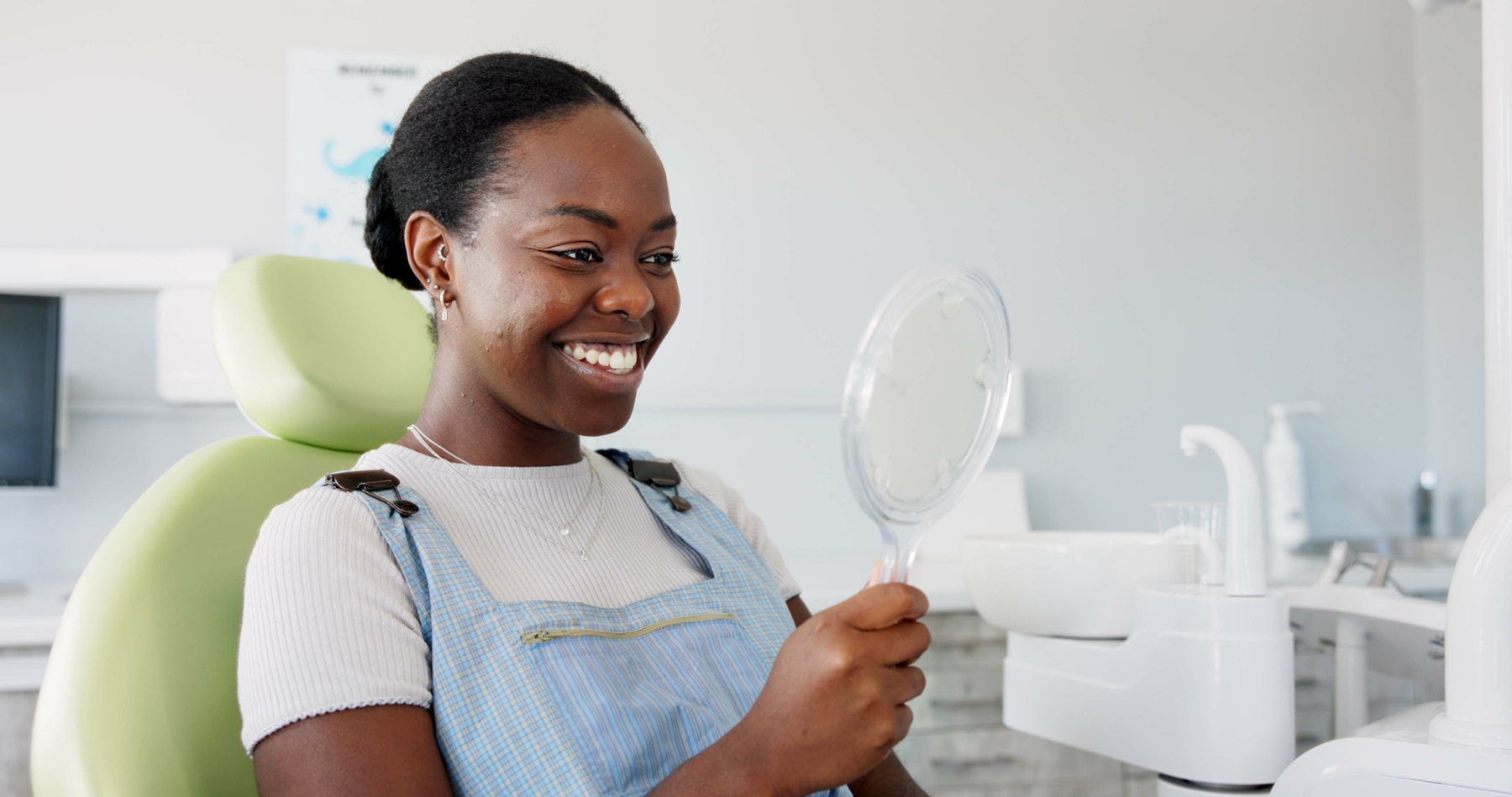 woman smiling in dentist exam chair | veneers knoxville