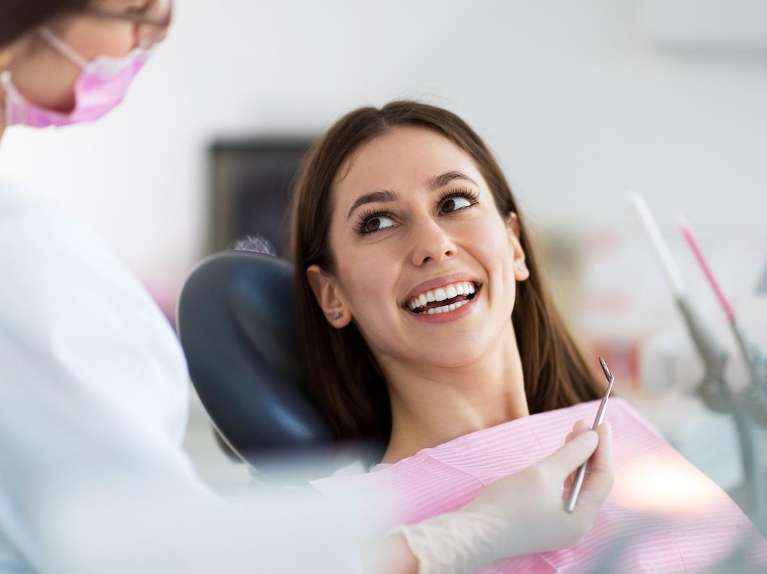 A smiling woman getting a dental exam