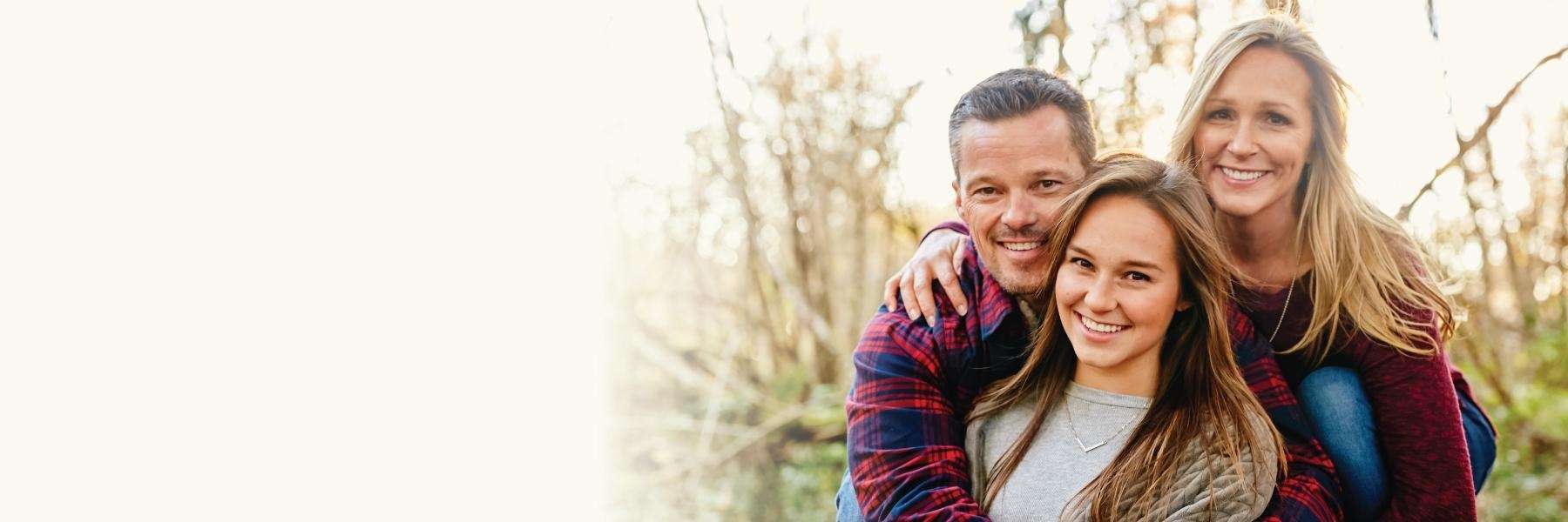 A smiling family in the woods in Knoxville, TN 